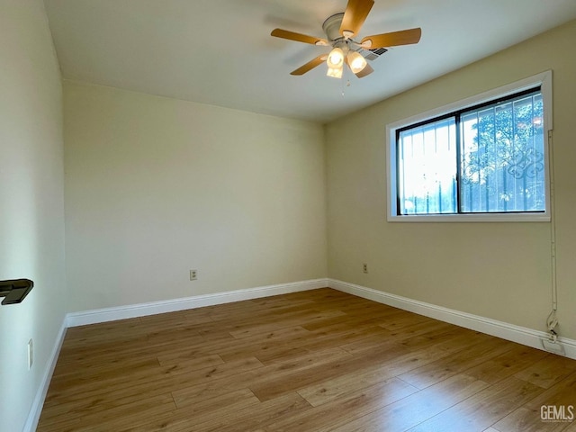 empty room featuring ceiling fan and light wood-type flooring