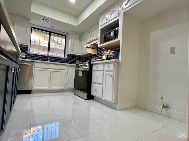 kitchen with white cabinetry, backsplash, and stainless steel appliances