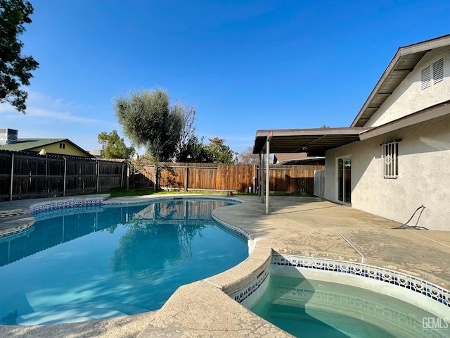 view of swimming pool with a patio area