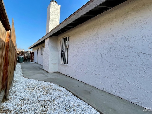 view of side of home with a patio