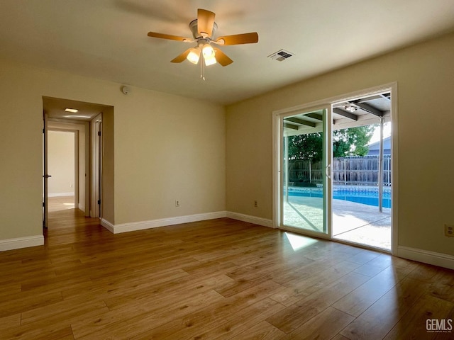 spare room with ceiling fan and light hardwood / wood-style floors