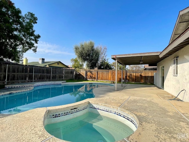 view of pool with an in ground hot tub and a patio area