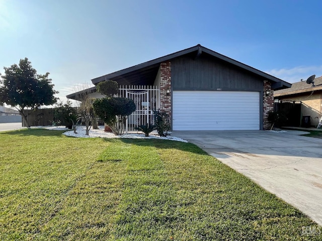 single story home featuring a garage and a front yard