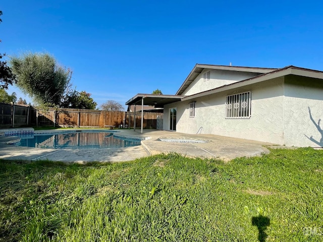 view of pool with a yard and a patio area