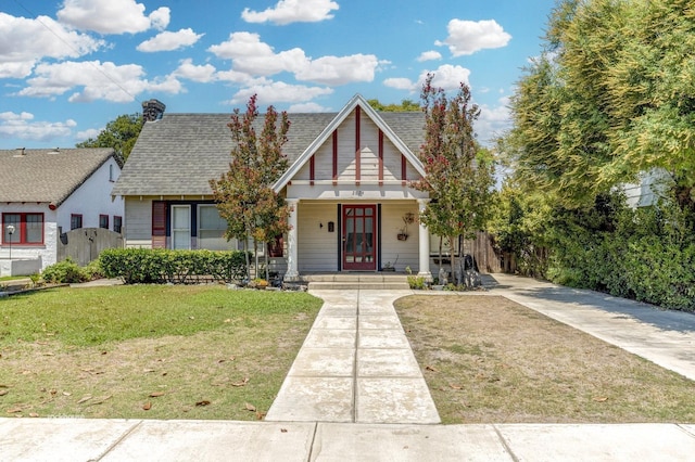 bungalow-style house featuring a porch and a front yard