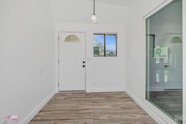 foyer with wood finished floors and baseboards