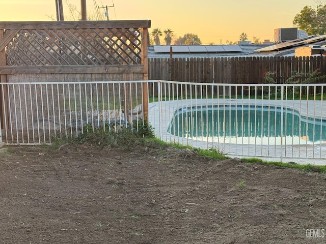 view of pool at dusk