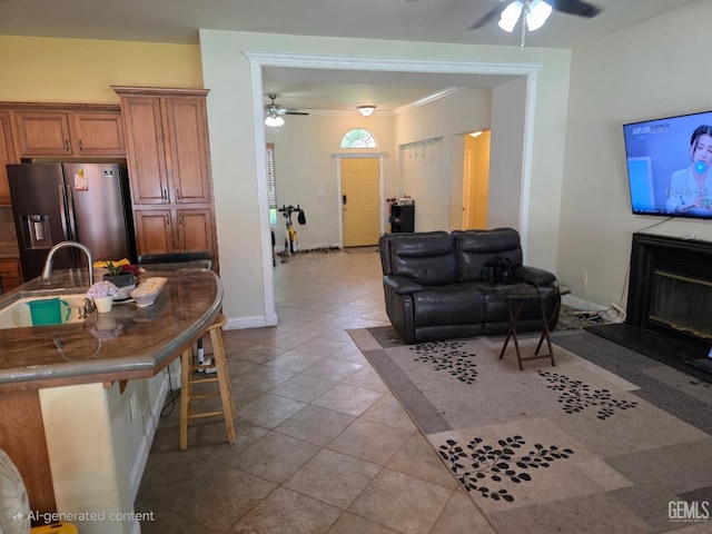 10302 Willow Bend Ct, Bakersfield, CA 93312 - living room with ceiling fan, a glass covered fireplace, and crown molding