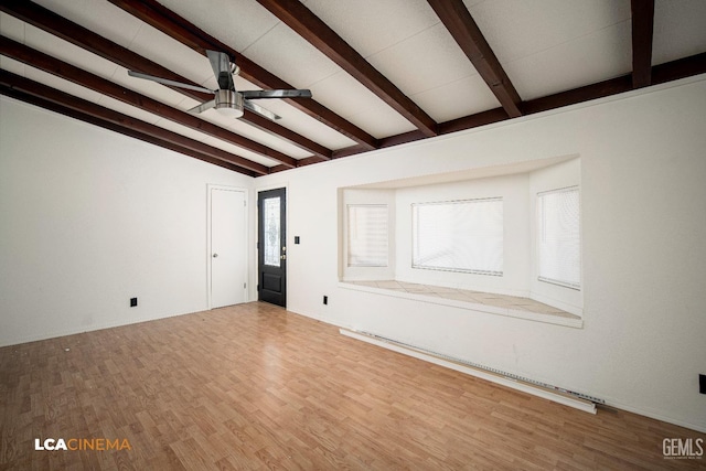 unfurnished living room with wood-type flooring, lofted ceiling with beams, and ceiling fan