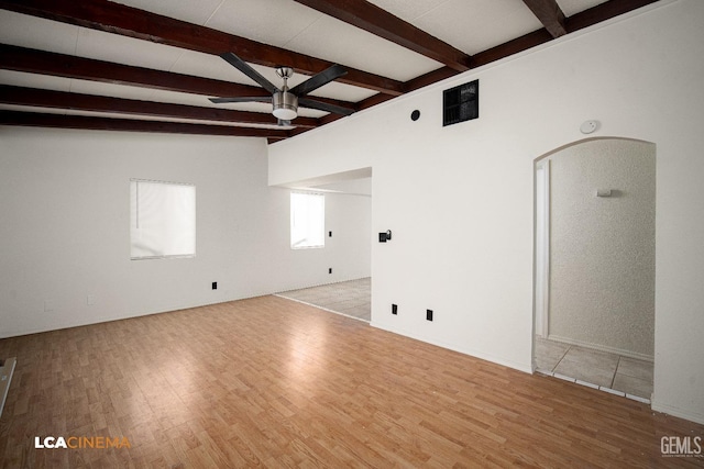 unfurnished living room with beamed ceiling, light hardwood / wood-style flooring, and ceiling fan