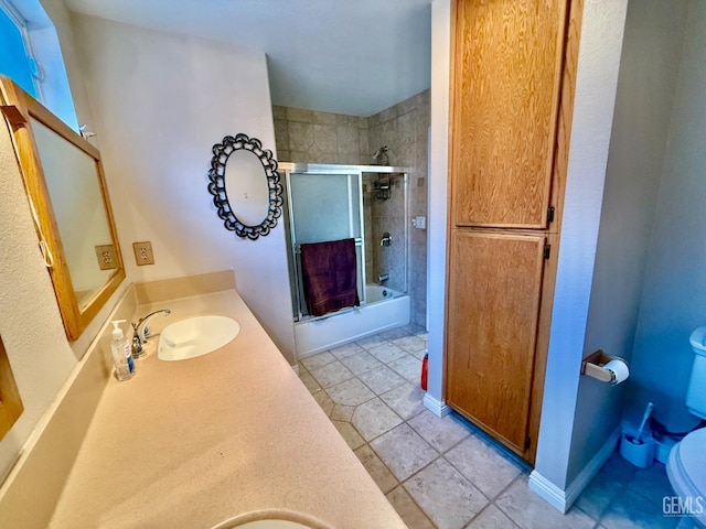 full bathroom featuring tile patterned flooring, vanity, enclosed tub / shower combo, and toilet