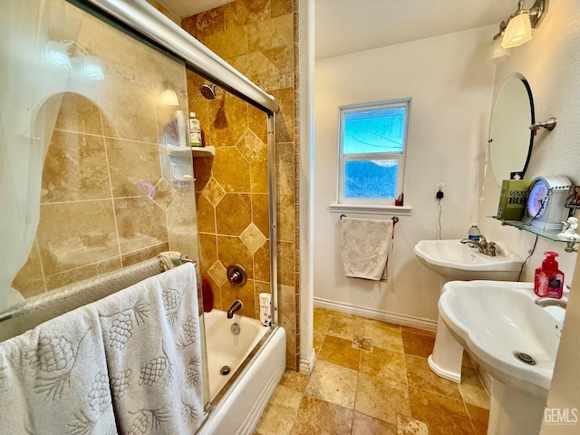 bathroom with bath / shower combo with glass door