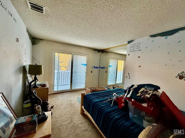 carpeted bedroom with multiple windows, access to outside, and a textured ceiling