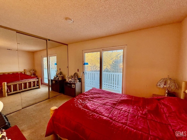 bedroom featuring carpet flooring, access to exterior, and a textured ceiling