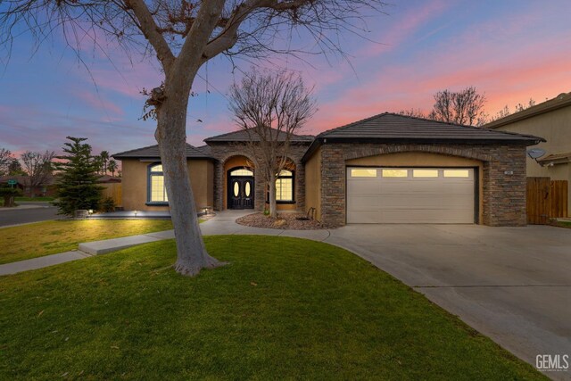 view of front of home with a front yard and a garage