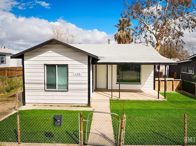 view of front of house featuring a front yard, a gate, fence private yard, and a patio