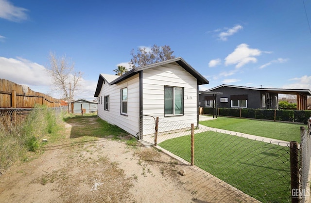 view of side of property featuring a lawn and fence private yard