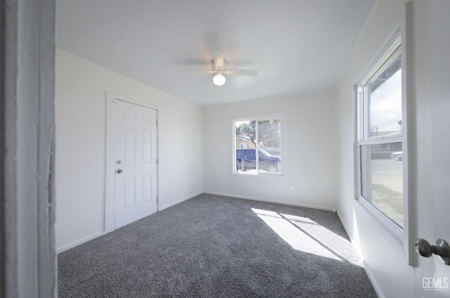 unfurnished room featuring baseboards, carpet floors, and ceiling fan