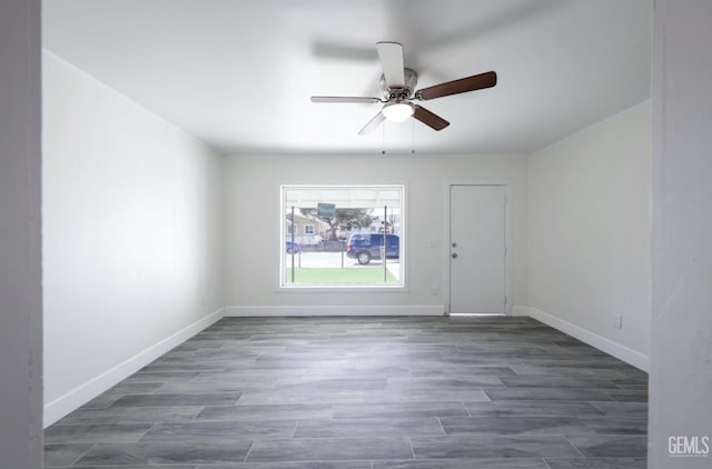 unfurnished room featuring ceiling fan, baseboards, and wood finished floors