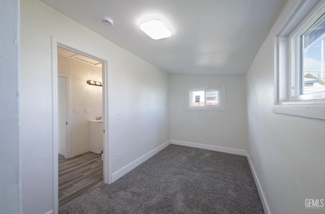 empty room featuring baseboards and carpet floors