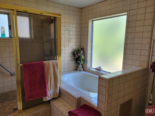 bathroom featuring separate shower and tub