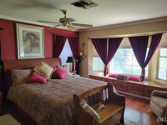 bedroom with wood-type flooring, ornamental molding, and ceiling fan