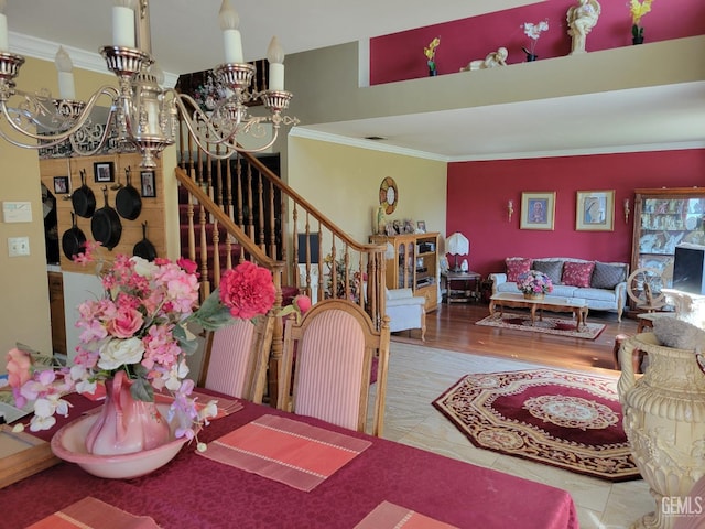 dining space featuring crown molding, a chandelier, and hardwood / wood-style floors