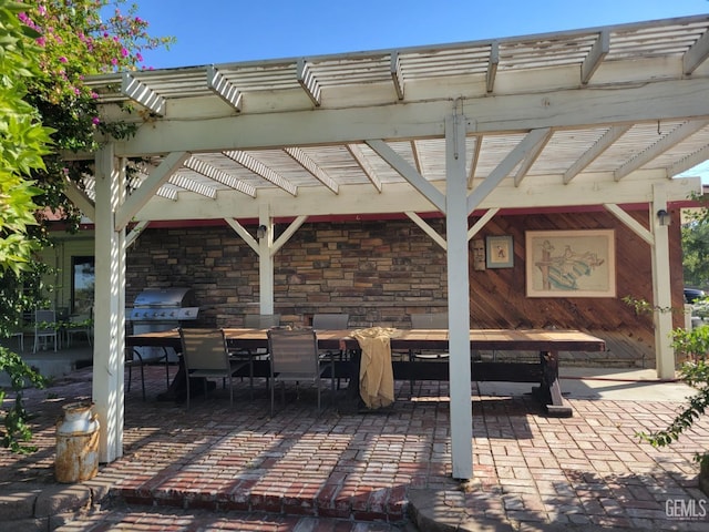 view of patio featuring grilling area and a pergola