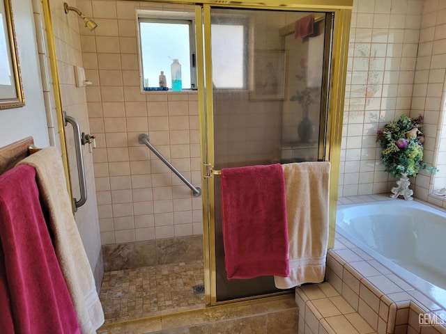 bathroom with separate shower and tub