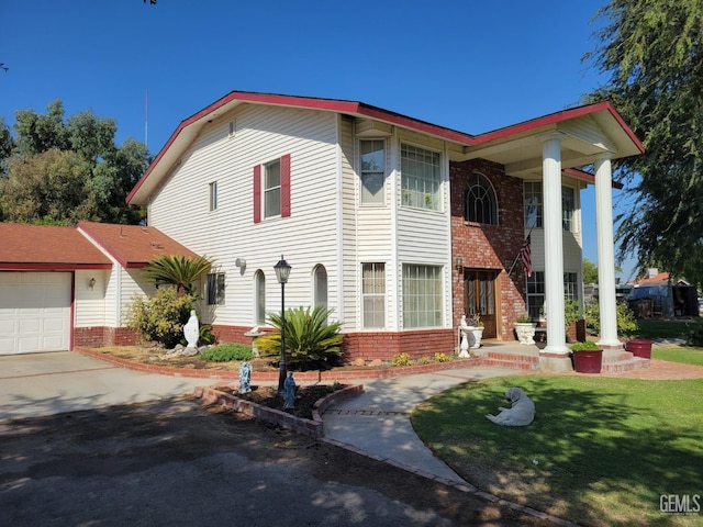 view of front of home featuring a garage and a front lawn