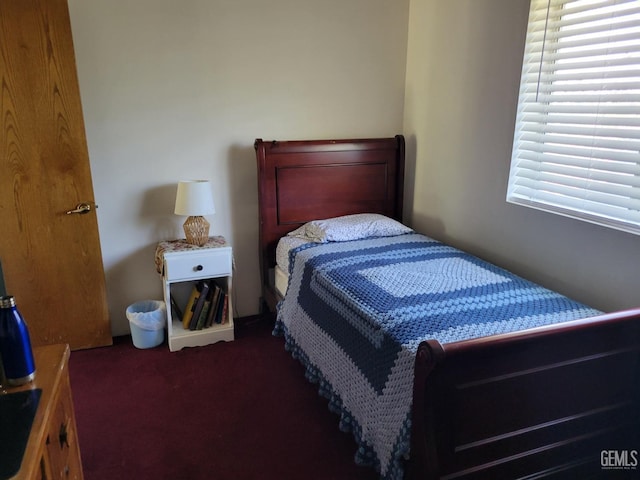 bedroom with dark colored carpet