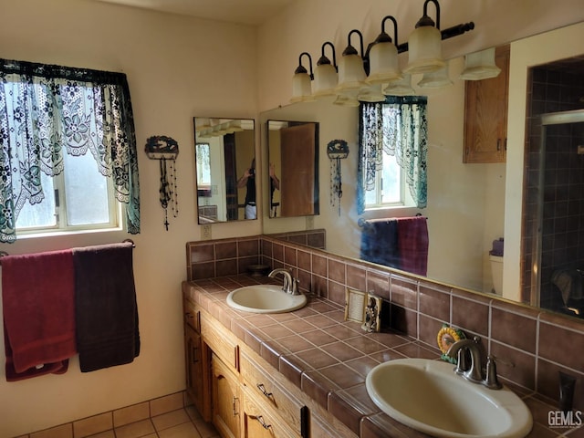 bathroom featuring vanity, toilet, tile patterned flooring, and backsplash