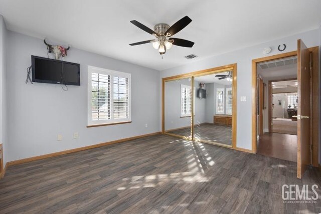 entrance foyer with french doors, ceiling fan with notable chandelier, dark hardwood / wood-style floors, and a brick fireplace