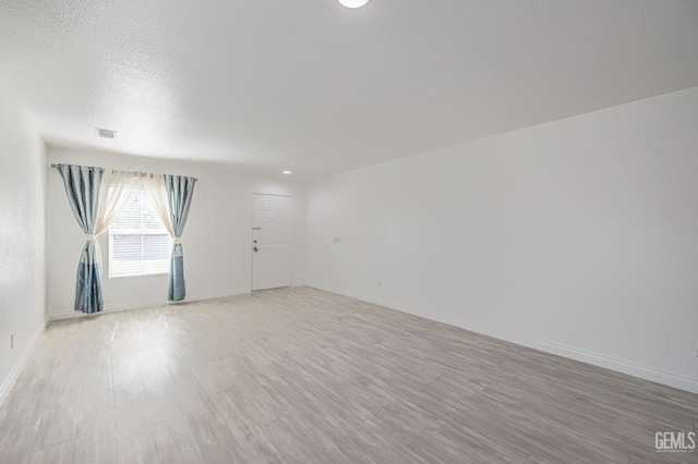 unfurnished room with hardwood / wood-style floors