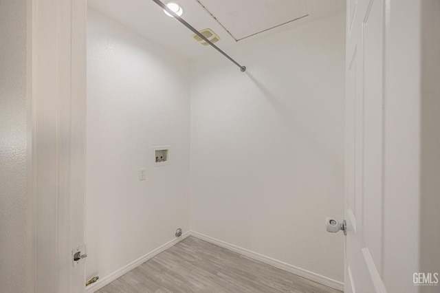 laundry room with hookup for a washing machine and light hardwood / wood-style flooring