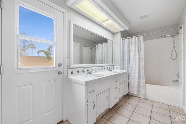 bathroom featuring tile patterned flooring, plenty of natural light, shower / bathtub combination with curtain, and vanity