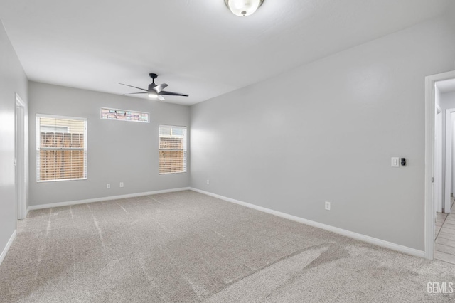 carpeted empty room featuring ceiling fan and a healthy amount of sunlight