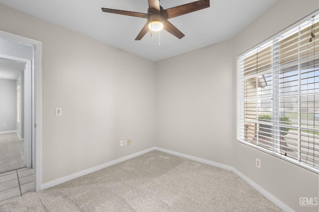 carpeted empty room featuring ceiling fan