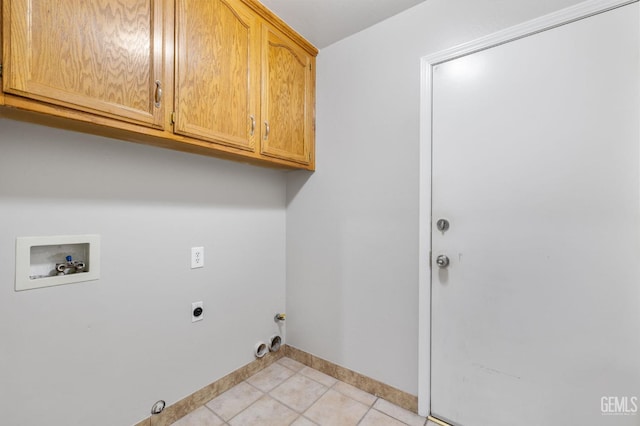 washroom with gas dryer hookup, cabinets, washer hookup, hookup for an electric dryer, and light tile patterned flooring