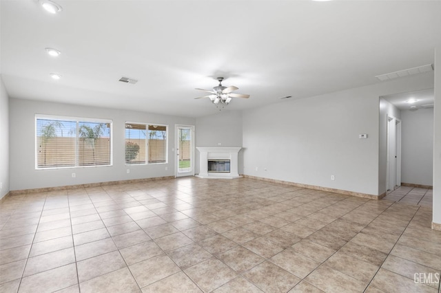 unfurnished living room with ceiling fan and light tile patterned floors