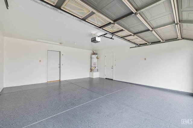 garage featuring a garage door opener and water heater