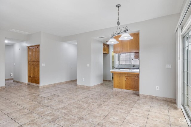 kitchen featuring pendant lighting and light tile patterned floors