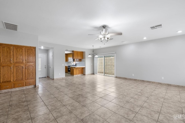 unfurnished living room featuring ceiling fan and light tile patterned flooring