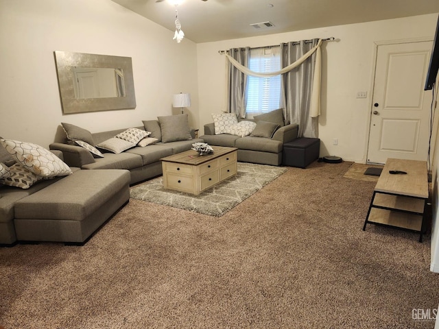 carpeted living room with vaulted ceiling