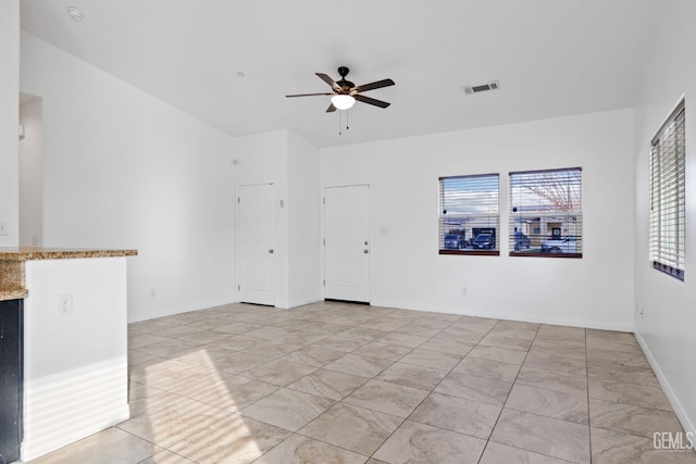 unfurnished room featuring ceiling fan, visible vents, and baseboards