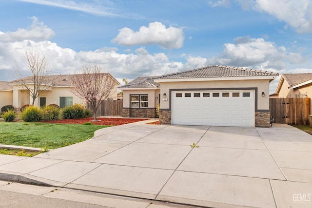 view of front of property with an attached garage, stone siding, fence, and stucco siding