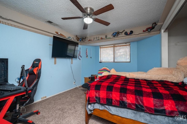 carpeted bedroom with ceiling fan and a textured ceiling