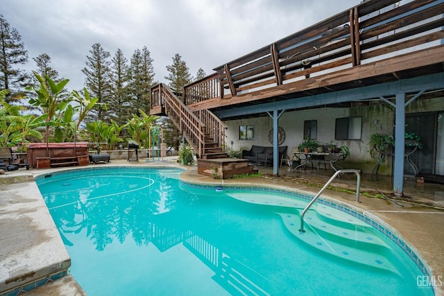 view of pool with a wooden deck, a pergola, a hot tub, and a patio