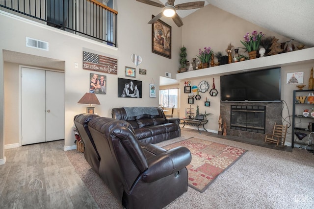 living room featuring hardwood / wood-style flooring, high vaulted ceiling, and ceiling fan