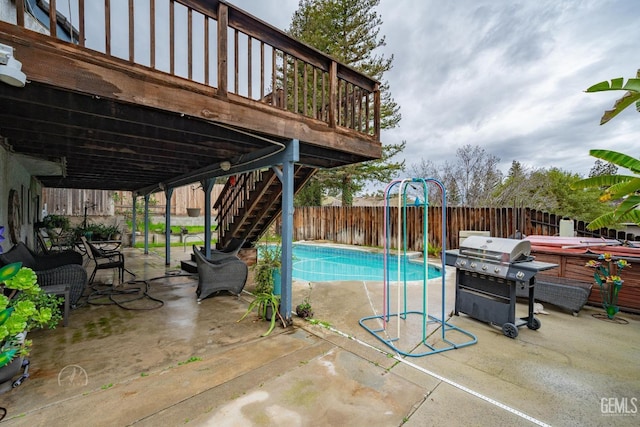 view of swimming pool with area for grilling, a wooden deck, a hot tub, and a patio